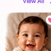 Smiling baby in a cream outfit